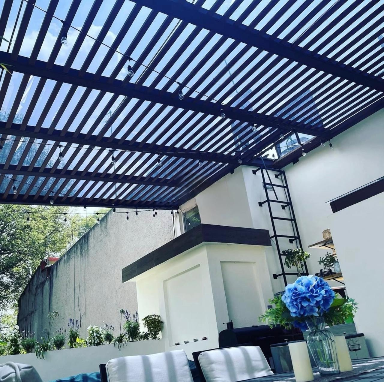 Pérgola negra sobre patio moderno